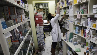 
              In this Tuesday, Dec. 11, 2012 photo, an Iranian pharmacist arranges medicine on shelves at a pharmacy in central Tehran, Iran. While medicine and humanitarian supplies are not blocked 